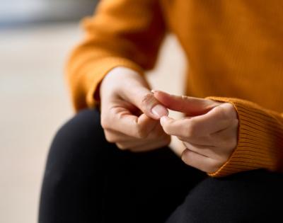 Close-up of woman picking at fingers